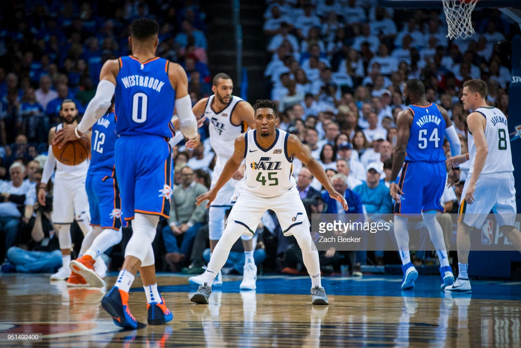 OKLAHOMA CITY, OK - APRIL 25: Donovan Mitchell #45 of the Utah Jazz guards Russell Westbrook #0 of the Oklahoma City Thunder in Game Five during Round One of the 2018 NBA Playoffs on April 25, 2018 at Chesapeake Energy Arena in Oklahoma City, Oklahoma. NOTE TO USER: User expressly acknowledges and agrees that, by downloading and or using this photograph, User is consenting to the terms and conditions of the Getty Images License Agreement. Mandatory Copyright Notice: Copyright 2018 NBAE (Photo by Zach Beeker/NBAE via Getty Images)