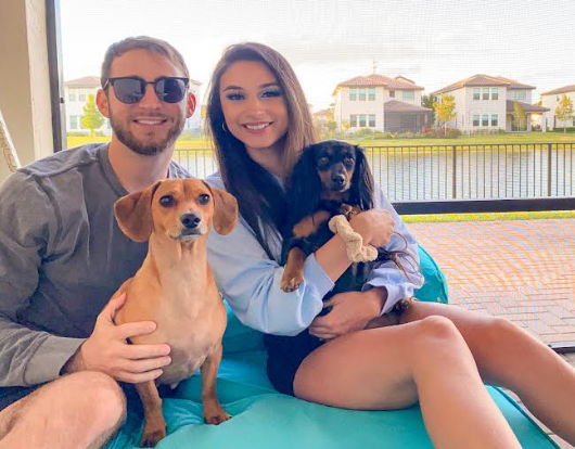 Ms. Spalla with her boyfriend and her two puppies in her home