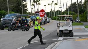 Crossing guard in front of golf cart