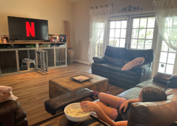 Kid watching Netflix eating popcorn