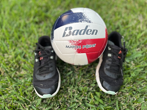 Volleyball with shoes in grass