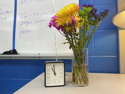 Flowers next to a clock