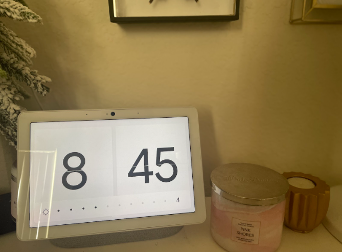 Desk with a digital clock and a candle 