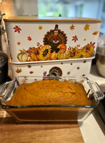 Pumpkin bread in front of a decorative Thanksgiving container