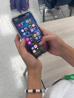 Photo of student using her phone in class.