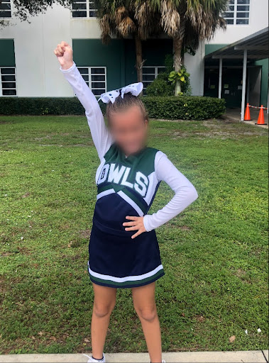 Photo of me in my old cheerleading outfit.