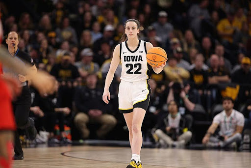 Caitlin Clark holding the ball in the middle of a game.