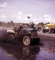 Swamp buggy driving through mud. Photo by State Archives of Florida.