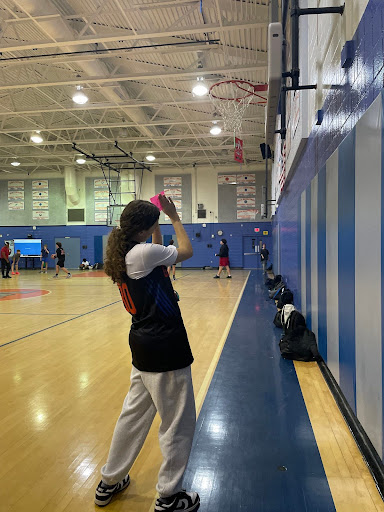 Photo of Rio T. standing by a basketball hoop.