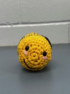 A small, crocheted bee