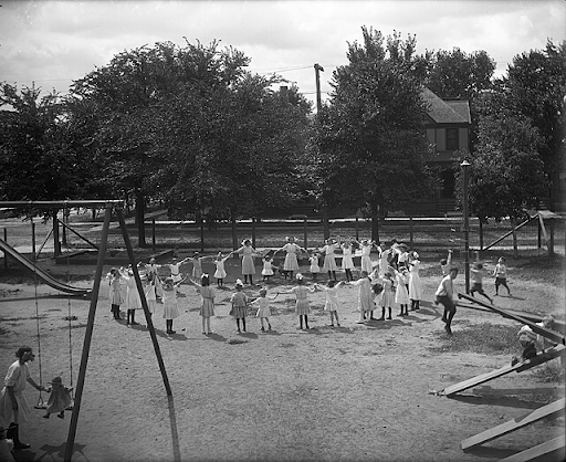 Kids are playing on a playground at their school.