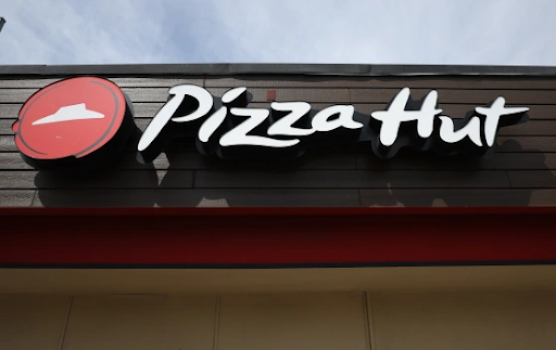 A sign is posted on the exterior of a Pizza Hut restaurant on March 25 2024 in San Pablo, California