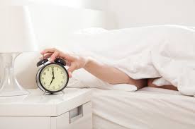 Image Of A Peron Tapping Their Alarm Clock