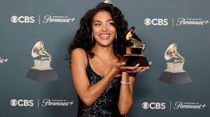 This is Olivia Dean holding her award at  the grammys