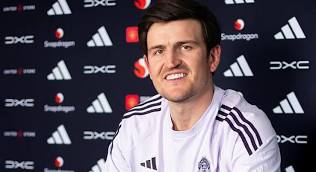  Harry Maguire at an event signing a contract 
