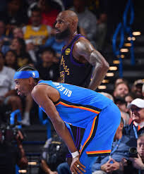 Shai and Lebron next to each other in the game.